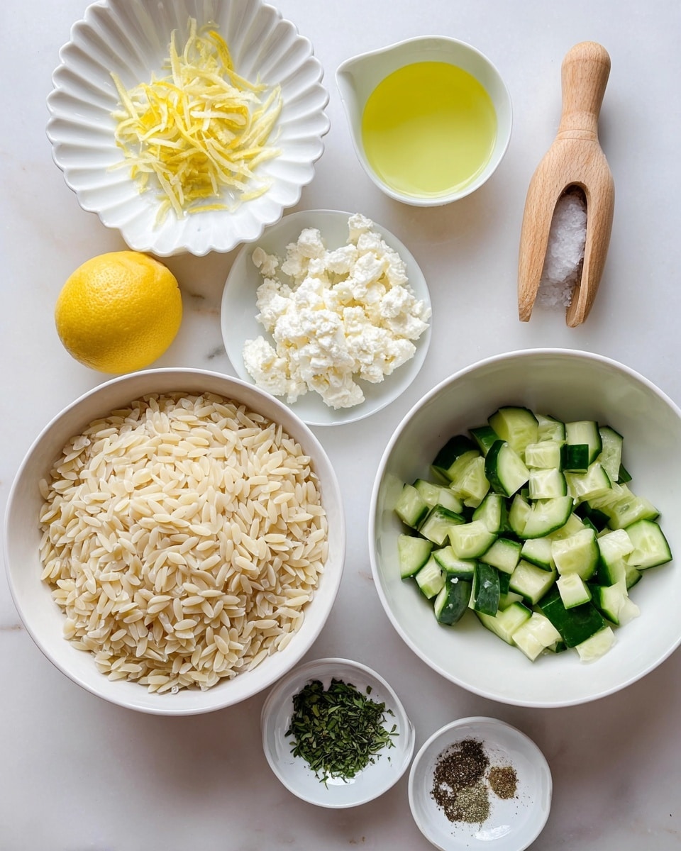 The image shows a white bowl filled with light beige orzo pasta on the left. To the right, a white bowl contains chopped small pieces of cucumber, showing bright green skin and light green flesh. Above this is a white plate with crumbled white cheese. Near the top center, a white scalloped bowl holds a pale yellow lemon juice liquid, and next to it is a white cup filled with clear golden olive oil. Above these are lemon zest shreds on a small white plate, and a halved lemon with a light yellow juicy inside beside a wooden juicer. At the bottom are three small white dishes with chopped dark green herbs and salt and pepper mix. Everything is placed on a smooth white marbled surface. photo taken with an iphone --ar 4:5 --v 7