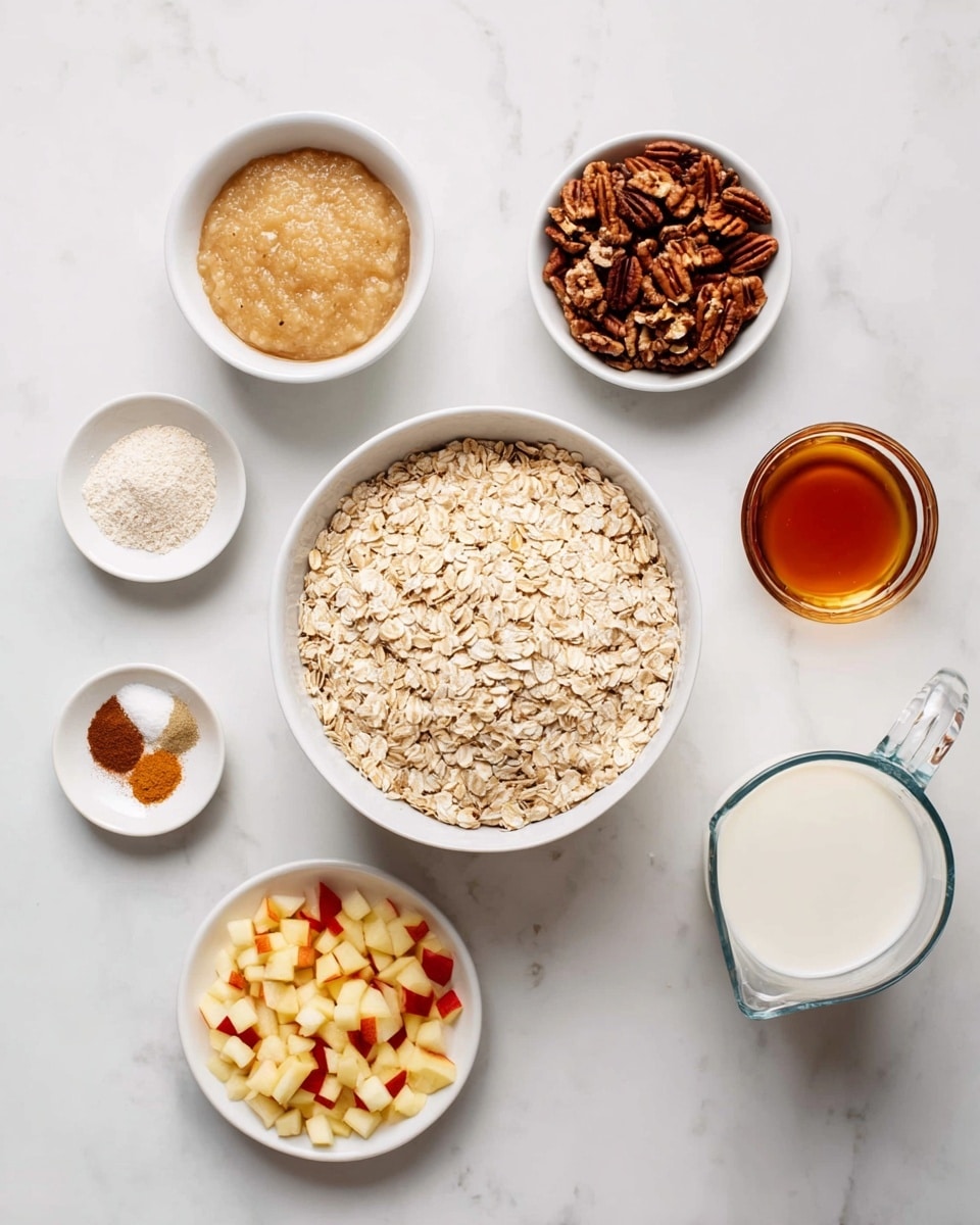A white bowl in the center is filled with light beige rolled oats, surrounded by smaller white bowls containing different ingredients. At the top left, a white bowl holds a smooth, creamy beige applesauce. At the top right, a white bowl is filled with chopped dark brown pecans. To the right of the center bowl, a clear glass measuring cup with a handle contains off-white oat milk. Below the oat milk, a small round glass container holds medium amber-colored maple syrup. Beneath the center, a small white bowl is filled with finely chopped light yellow and red apple pieces. To the bottom left, a white plate contains three small piles of dry spices, including ground cinnamon (brown), baking powder, and baking soda (white). All items are laid out on a white marbled surface. Photo taken with an iphone --ar 4:5 --v 7