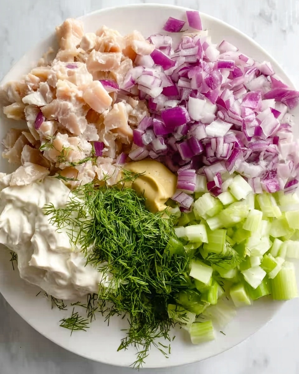 The image shows a close-up of five different ingredients neatly placed on a white plate, all on a white marbled surface. In the top left corner, there is a layer of small, light pink chunks of chicken. Next to it on the right, there's a layer of finely chopped red onions with a mix of white and purple colors. Below the onions, on the right side, are pale green celery pieces cut into small cubes. Towards the bottom left, there is a layer of creamy white mayonnaise topped with fresh green dill. Next to the mayonnaise is a small serving of pale yellow mustard. The layers are arranged closely but separate on the white plate, creating a colorful, fresh look. Photo taken with an iphone --ar 4:5 --v 7