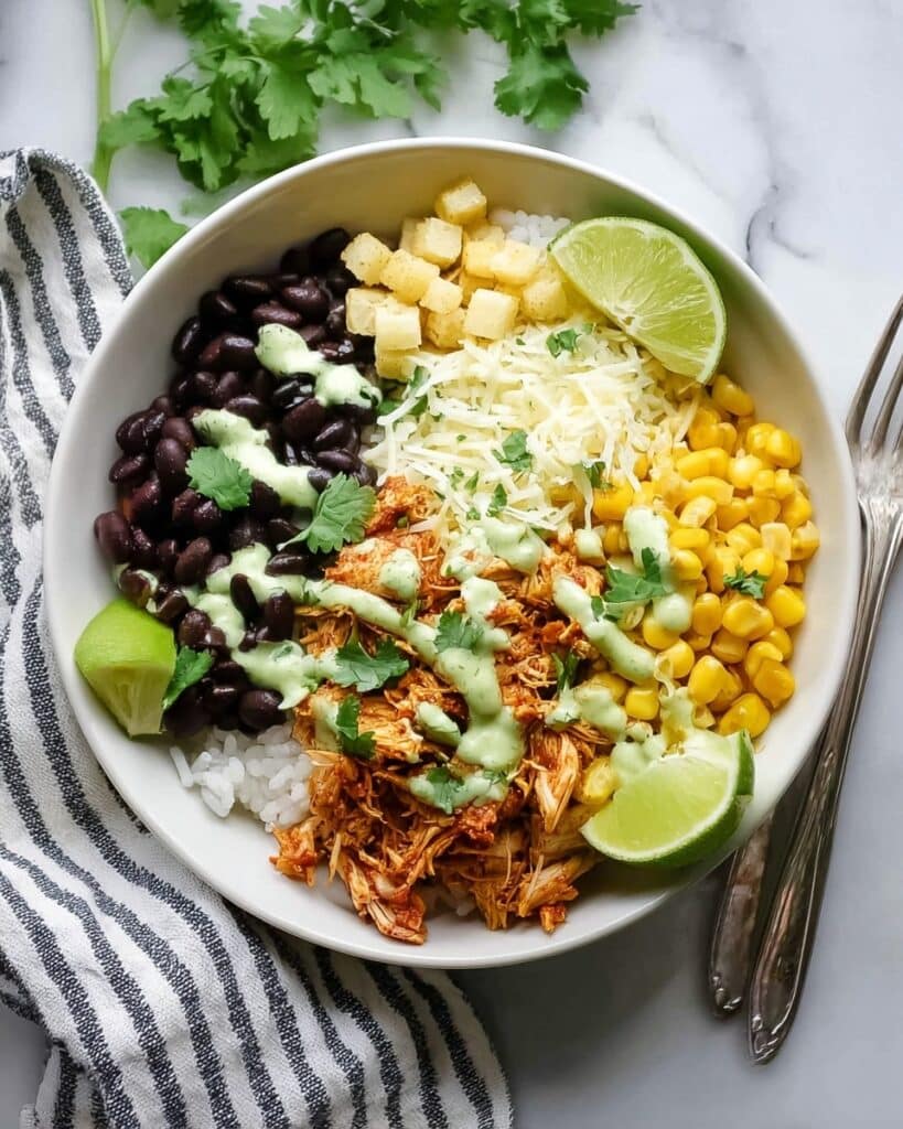 Slow Cooker Mexican Chicken Burrito Bowl with Rice, Black Beans, Corn, Avocado, and Cilantro Lime Dressing Recipe
