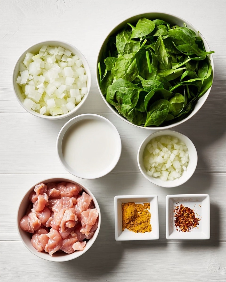 A white marble surface holds five white bowls with different food items arranged evenly spaced. The top left bowl contains a layer of diced white onions showing a rough texture. To its right, a larger bowl is filled with fresh green spinach leaves that look crisp and piled high. Below the onions, a smaller bowl holds a white liquid, smooth in texture. Centered at the bottom, a medium white bowl contains small pieces of raw pink chicken meat with a moist look. On the bottom right, two small white square dishes hold finely minced yellow ginger and reddish-brown ground spice powder. photo taken with an iphone --ar 4:5 --v 7