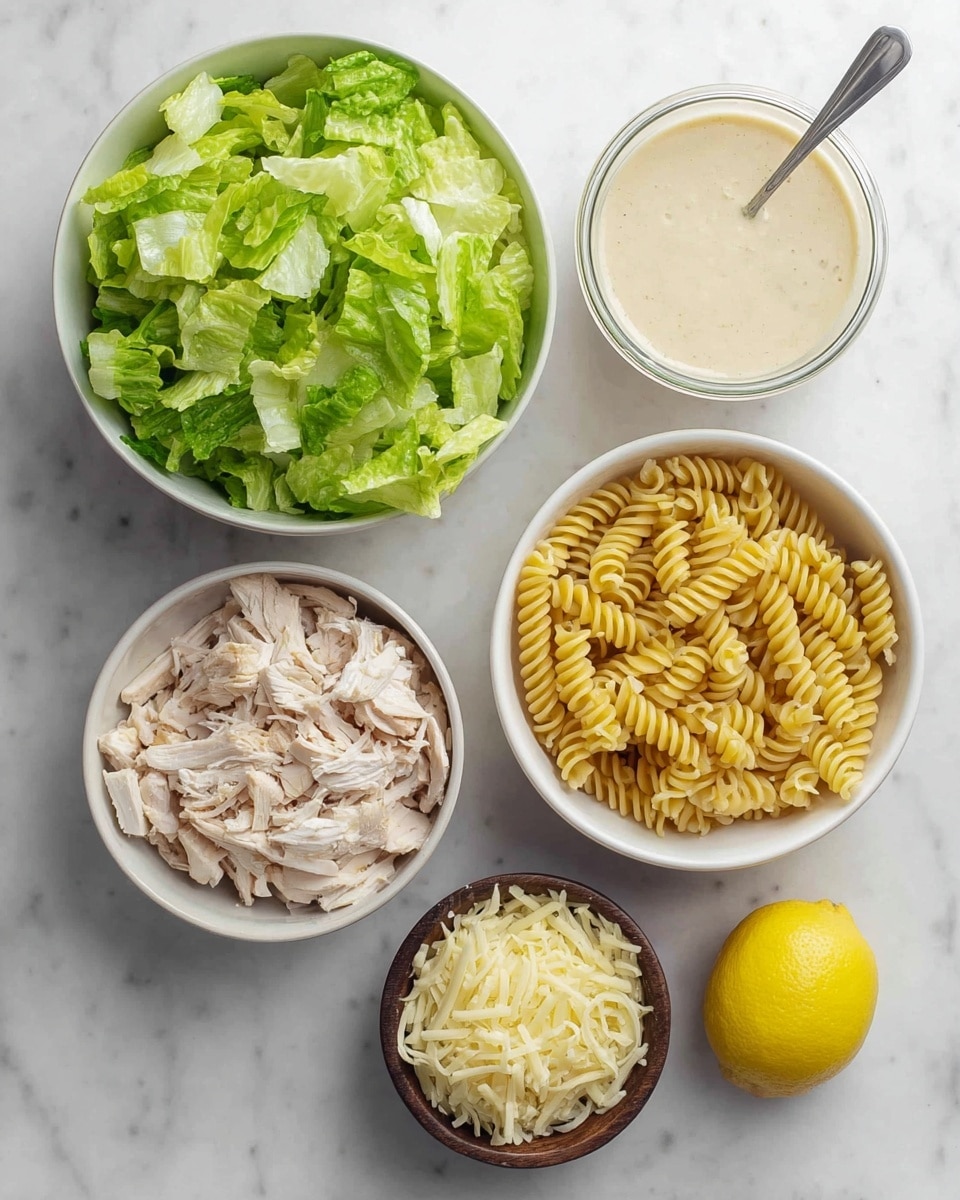 The image shows six separate items placed on a white marbled surface. At the top left is a white bowl filled with bright green chopped lettuce, showing fresh leafy texture. To the right of that bowl, there is a glass jar filled with creamy light beige dressing and a metal spoon inside. Below the jar is a white bowl with cooked spiral pasta, yellow and firm in texture. At the bottom left, there is another white bowl containing shredded light beige cooked chicken meat. Next to that bowl is a small dark wooden bowl holding shredded pale yellow cheese. To the bottom right corner, a half lemon with bright yellow flesh is placed neatly. The items are clean and arranged simply. photo taken with an iphone --ar 4:5 --v 7
