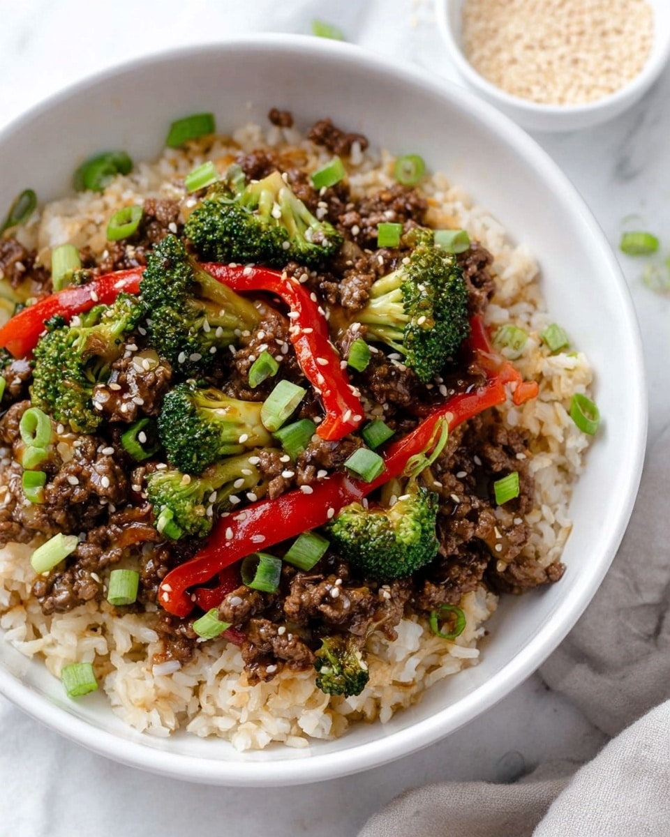A white bowl filled with a layer of cooked brown rice at the bottom. On top of the rice, there is a mix of cooked ground beef, bright green broccoli florets, and sliced red bell peppers. The beef looks shiny with sauce, and the vegetables are vibrant and fresh. Small white sesame seeds and chopped green onions are sprinkled over the dish. The bowl sits on a white marbled surface with a small white bowl of sesame seeds in the background. photo taken with an iphone --ar 4:5 --v 7