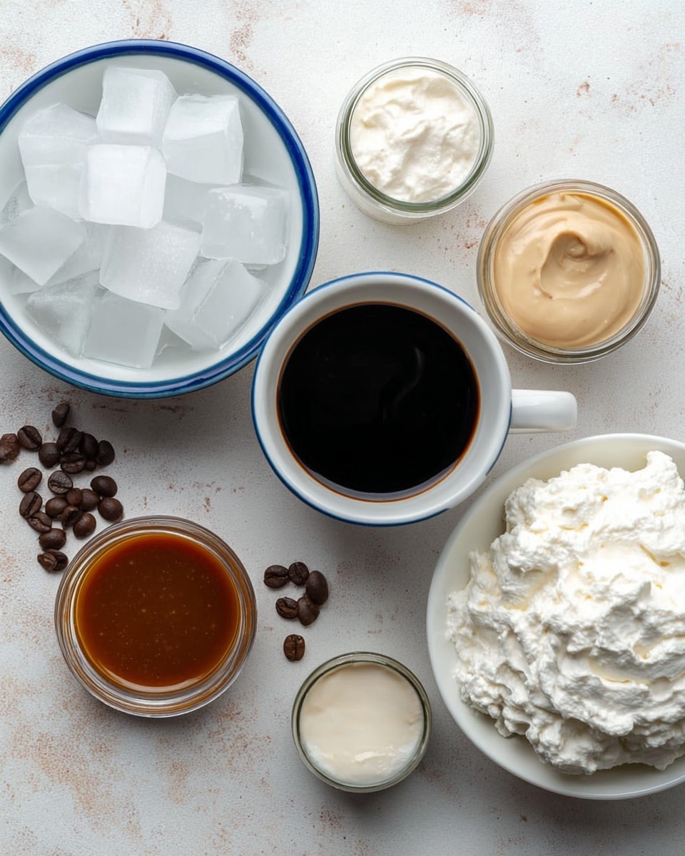 The image shows a top view of several small containers on a white marbled surface. In the center, there is a white cup with a blue rim filled with dark black coffee. To the left, a white bowl with a blue rim is filled with large white ice cubes. On the right side, a white bowl holds a large amount of fluffy, white whipped cream. Around these, there are small glass jars; one with light brown caramel sauce at the top right, one with light beige cream below the coffee cup, and a small clear jar with white cream or milk to the top left. Scattered coffee beans add small dark brown spots across the surface. Photo taken with an iphone --ar 4:5 --v 7
