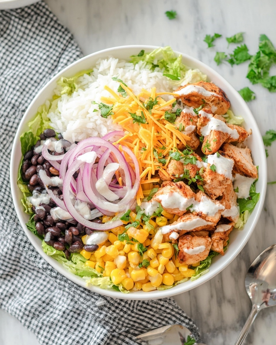 A white bowl on a white marbled surface holds a four-layered dish, starting with a base of shredded green lettuce. On top of the lettuce, there is a layer of white rice, arranged on one side. Next, there are separated sections of bright yellow corn and black beans with a dollop of white sauce on the beans. On top of the rice and beans, slices of cooked, light brown chicken pieces are placed on one side, drizzled lightly with white sauce. Thin, translucent rings of red onion are spread over the corn and chicken, sprinkled with finely chopped green herbs and thin strands of orange shredded cheese. The top has a light garnish of fresh green cilantro. A white and black checked cloth with a shiny silver spoon rests partially under the bowl. Photo taken with an iphone --ar 4:5 --v 7