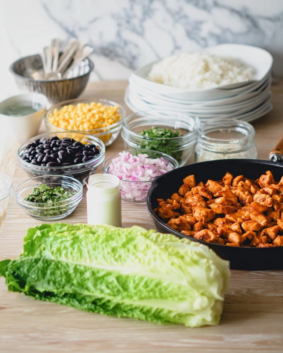 The image shows a cooking setup with several ingredients and a black pan filled with cooked small pieces of orange-colored chicken on the right side. In front of the pan, there is a fresh green romaine lettuce head lying horizontally. Moving left from the lettuce, there are small glass bowls containing black beans, pickled pink onions, yellow corn, and chopped green herbs. A small white cup of sauce is also visible near the lettuce. Behind these, a glass bowl filled with white rice and stacked white bowls with silver forks inside are set on a light wood table. The background is a white marbled texture. Photo taken with an iphone --ar 4:5 --v 7