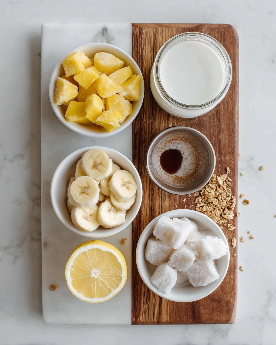 The image shows a white marbled board with a wooden section on the top right. On this board, there are five small white bowls with different ingredients. The top left bowl contains frozen yellow mango chunks with a rough icy texture. To its right, there is a glass jar filled with white liquid, likely milk or a milk substitute. Below the jar, a bowl holds frozen banana slices covered in frost, showing a light yellow color. Next to the bananas on the bottom right is a bowl with white, chunky frozen coconut pieces. On the bottom left, a halved lemon with a bright yellow flesh sits next to a small bowl filled with dark brown liquid, probably syrup. There are small crumbs of granola scattered on both sides of the board. The photo is taken with an iphone --ar 4:5 --v 7