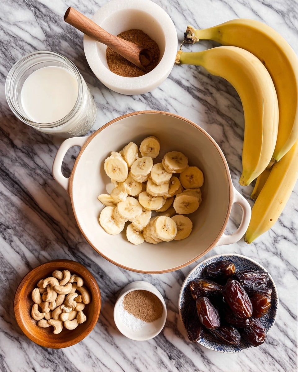 A white bowl with two handles in the center holds a layer of light yellow banana slices arranged loosely with some overlapping pieces, all on a white marbled surface. To the right of the bowl, there is a bunch of three whole bananas with bright yellow skin. On the top left corner is a white marble mortar with a small wooden spoon filled with brown cinnamon powder. Below that, a jar filled halfway with white milk sits on the marble surface. To the left of the bowl, a small tan wooden bowl is filled with light beige cashew nuts spread evenly. Below this wooden bowl, a small white dish has a swirl pattern of white salt and brown cinnamon powder. On the lower right side, a white bowl holds a few glossy dark brown dates with a wrinkled texture. photo taken with an iphone --ar 4:5 --v 7