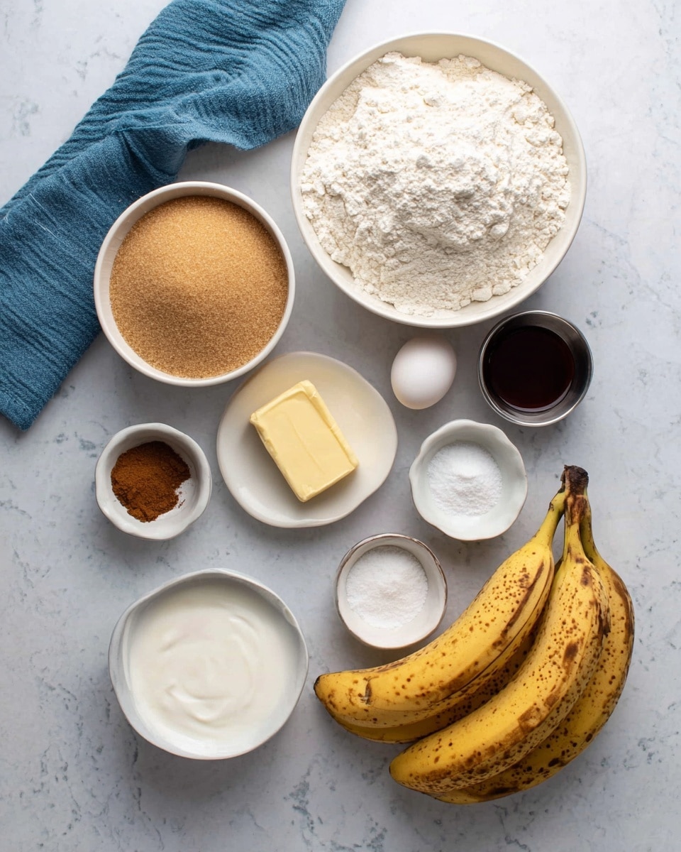 The image shows baking ingredients arranged on a white marbled surface. At the center top, there is a medium white bowl filled with white flour that has a slight uneven texture. Below it to the left is another white bowl filled with light brown sugar, showing a grainy texture. To the bottom left, there is a smaller white bowl with smooth white yogurt. On the bottom right near the center is a white bowl holding a solid, light yellow stick of butter. Three ripe bananas with brown spots are placed on the right side. Above the butter are three small silver bowls containing white salt, white baking soda, and brown cinnamon powder respectively. A white egg is placed between the flour and the brown sugar, and a small silver cup of dark brown vanilla extract is below the cinnamon. A blue cloth is partially visible on the top left corner. photo taken with an iphone --ar 4:5 --v 7