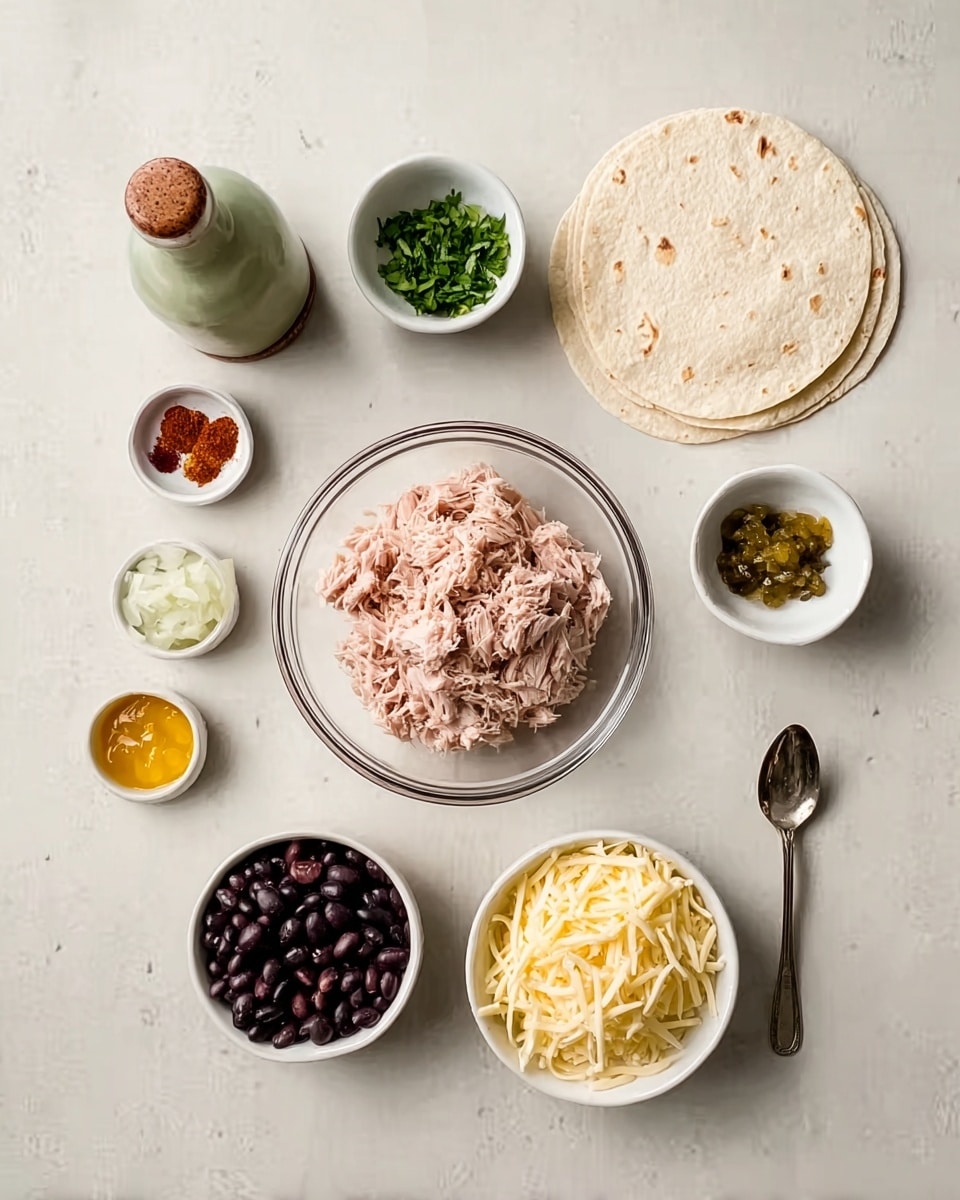 The image shows a white marbled surface with neatly arranged ingredients for a dish. There is a clear glass bowl with light pink shredded tuna placed near the center. To the right, there is a small white bowl filled with chopped green herbs. Next to it, there is a small white bowl with dark black beans. Above these, a small white bowl holds diced white onions. Above and to the right are two white flat tortillas stacked. Near the top center, a white bowl contains shredded light yellow cheese. A small white dish holds a mix of spices in different colors: black, white, red, and green. A silver spoon with yellow chili or pepper jelly rests near the bottom. At the top left corner, there is a ceramic bottle with a green top and a brown band near the bottom. The composition is clean and well spaced, with soft lighting. Photo taken with an iphone --ar 4:5 --v 7