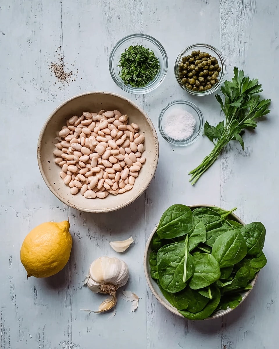 The image shows a top-down view of ingredients on a white marbled surface. On the left, there is a beige bowl filled with many light pink beans. Below it, there is a lemon, three cloves of garlic, a small clear bowl of salt and pepper, and a small bunch of fresh parsley with green leaves. On the right side, there is a white bowl filled with fresh green spinach leaves. Above the beans bowl, there are two small clear bowls one filled with green chopped herbs and the other with green capers. The colors are soft and natural with a simple, fresh look. Photo taken with an iphone --ar 4:5 --v 7