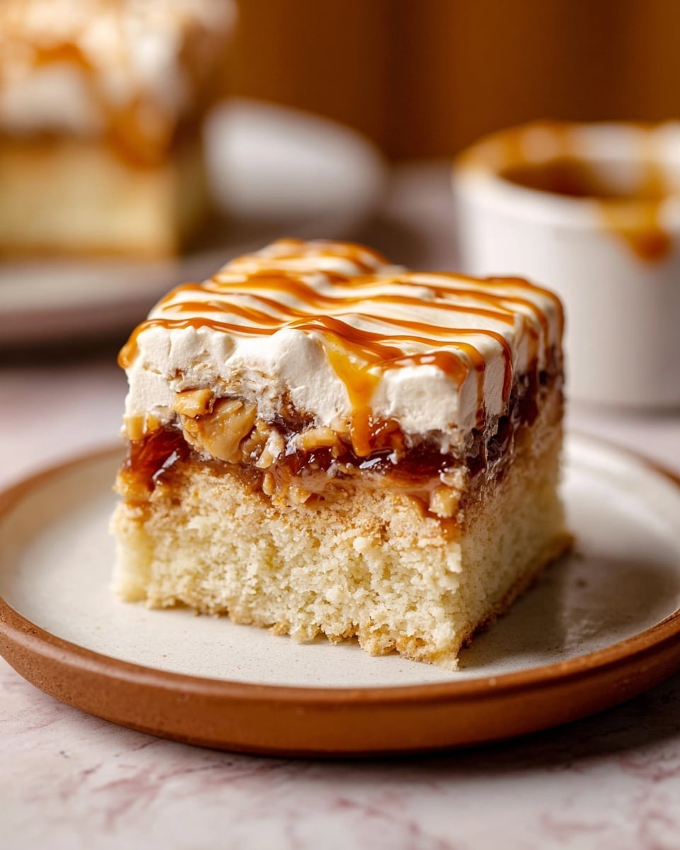 A close-up of a three-layer dessert piece on a white plate with a brown rim, placed on a white marbled surface. The bottom layer is a thick, light golden cake with a soft texture. The middle layer is a sticky, dark caramel-like filling with a shiny surface and some chunks visible. The top layer is a thick, creamy white frosting with a smooth texture, adorned with a shiny drizzle of caramel sauce in stripes. In the background, a blurred dessert piece and a white ramekin with caramel sauce can be seen. Photo taken with an iphone --ar 4:5 --v 7