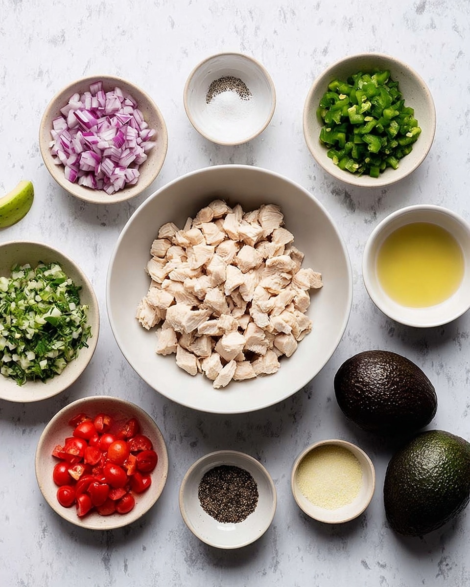 The image shows a collection of small white bowls and dishes arranged neatly on a white marbled surface. At the center is a large white bowl filled with chopped cooked chicken pieces in light beige color. Surrounding it are smaller white bowls and dishes containing various ingredients: finely chopped red onions with a purple and white mix, chopped fresh green herbs, bright red diced tomatoes, and diced green chili peppers. There are also two whole dark green avocados on the right side. Three small bowls contain ground black pepper, coarse white salt, a pale yellow liquid likely lemon juice, and a pale yellow powder. The colors of the ingredients are vivid and fresh, contrasting with the clean, white bowls and surface. photo taken with an iphone --ar 4:5 --v 7