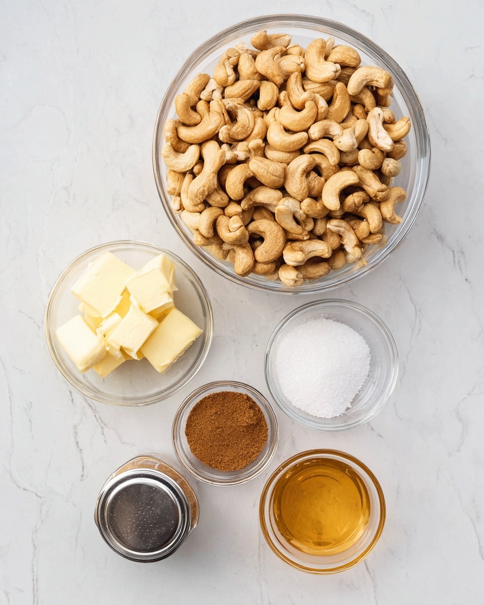 A clear glass bowl filled with a large pile of light brown cashew nuts sits at the top center of the image on a white marbled surface. Below it, small clear glass bowls hold three light yellow cubes of butter, white granulated sugar, brown sugar, white coarse salt, and golden honey. A small, clear jar filled with cinnamon powder with a silver lid is positioned near the butter and sugar bowls. The arrangement is neat and all containers are transparent for easy viewing of their contents. Photo taken with an iphone --ar 4:5 --v 7
