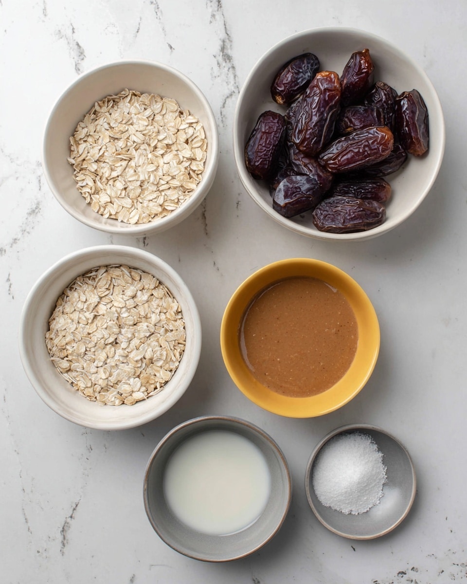 The image shows six small white bowls on a white marbled surface. The largest bowl in the top right is filled with dark brown dates that have a shiny and wrinkled texture. Below it to the right is a medium bowl with smooth, light brown almond butter. To the left of the almond butter is another medium bowl filled with light beige rolled oats, showing a flat and rough texture. Below the oats and almond butter are three smaller bowls: one yellow bowl containing white salt crystals, a white bowl with a smooth, off-white liquid, and a gray bowl holding a small amount of white powdery baking soda. photo taken with an iphone --ar 4:5 --v 7