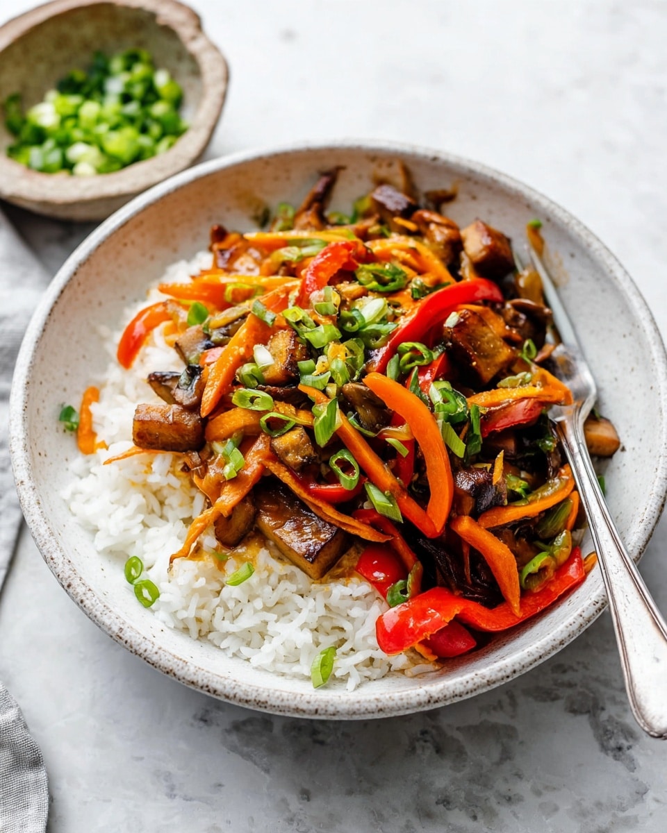 A white speckled bowl sits on a white marbled surface filled with a base layer of fluffy white rice. On top, a colorful stir-fry layer with thin orange carrot strips, red bell pepper slices, brown mushroom pieces, and small brown tofu chunks is arranged, garnished with bright green chopped scallions scattered over the top. A silver fork rests inside the bowl, angled diagonally with its prongs partly embedded in the rice and vegetables. To the side, a small rustic bowl with more chopped scallions is partially visible. Photo taken with an iphone --ar 4:5 --v 7