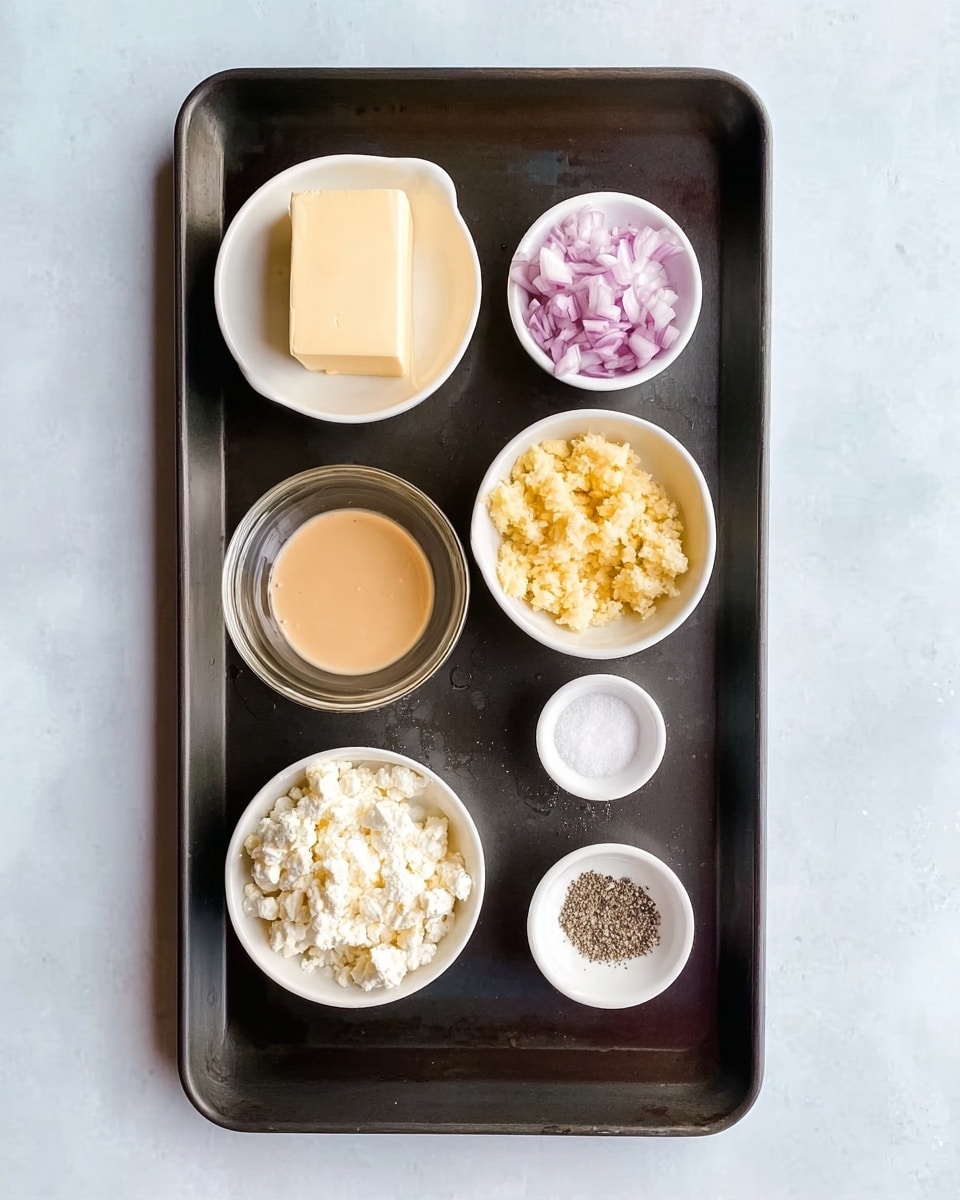 A dark baking tray is placed on a white marbled texture. On the tray, six small white bowls and one block of butter are arranged. The block of butter is at the top left of the tray. Below it, a white bowl contains finely chopped shallots with a pale purple color. To the right of the shallots, there is a white bowl filled with light yellow minced garlic. Below the garlic, a transparent glass bowl holds a smooth, light orange paste. At the bottom left of the tray, a white bowl is filled with crumbled white cheese. Next to the cheese, at the bottom right, a small white bowl contains a mix of black pepper and white salt. The overall look is neat with different layers of colors and textures. photo taken with an iphone --ar 4:5 --v 7