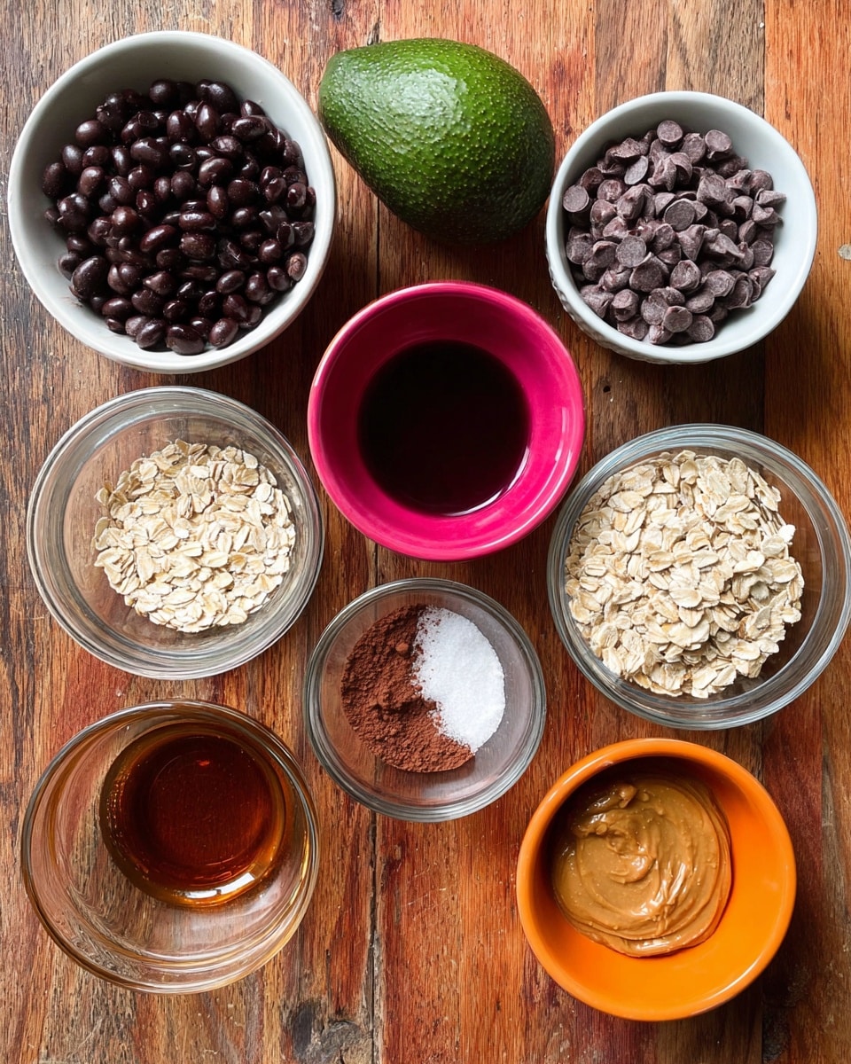 The image shows eight small bowls of ingredients placed on a wooden surface. From top left to bottom right: a white bowl filled with black beans, a dark green avocado, a small bright pink bowl with dark red liquid, a clear bowl with dark brown chocolate chips, a clear bowl with brown cocoa powder, white powder, and salt, a glass bowl with dark amber syrup or honey, a small white bowl of rolled oats, and an orange bowl holding light brown peanut butter. The white marbled background is visible at the sides. Photo taken with an iphone --ar 4:5 --v 7